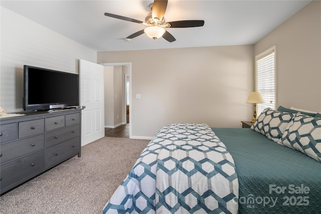 carpeted bedroom with ceiling fan and baseboards