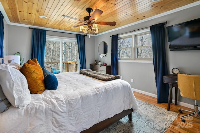 bedroom with access to exterior, crown molding, wood finished floors, wooden ceiling, and baseboards