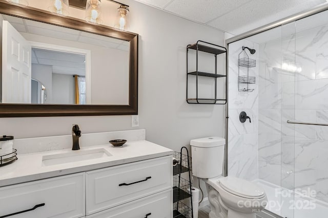 bathroom with toilet, a shower stall, and vanity