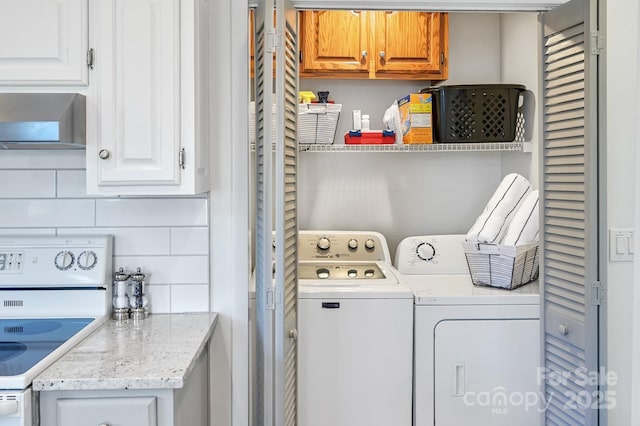 washroom featuring laundry area and separate washer and dryer