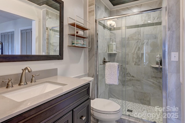 full bath featuring toilet, a shower stall, and vanity