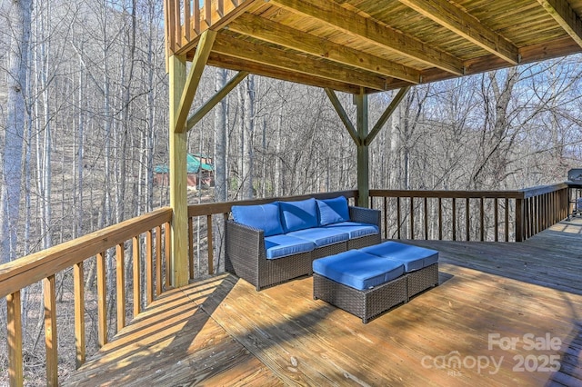 wooden terrace with an outdoor living space