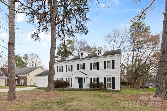 view of front of home with a garage, driveway, and a front lawn