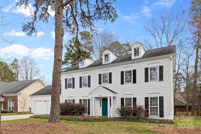 view of front of property with an attached garage and concrete driveway