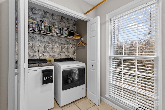 laundry room featuring laundry area, light tile patterned floors, and washing machine and clothes dryer