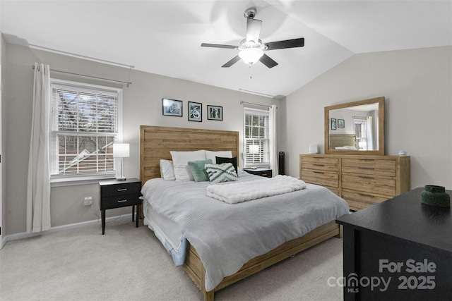 bedroom with baseboards, vaulted ceiling, a ceiling fan, and light colored carpet