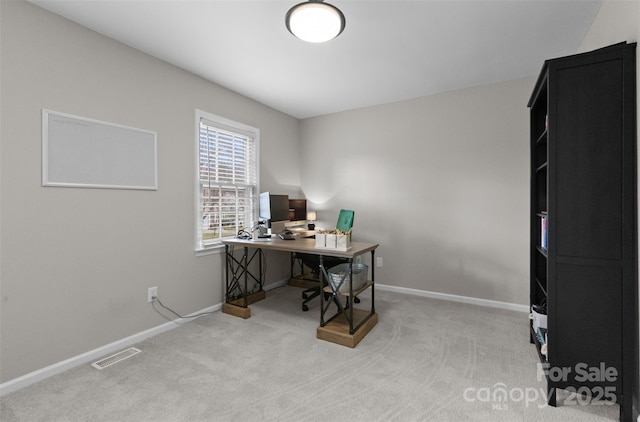 carpeted office space featuring baseboards and visible vents