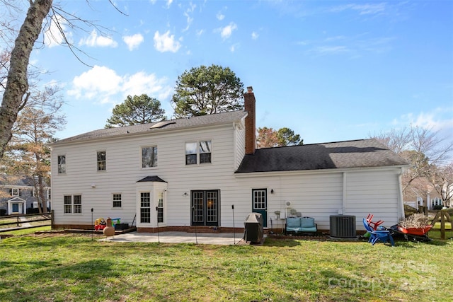 back of house featuring a patio, a chimney, central air condition unit, a lawn, and fence