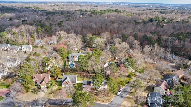 birds eye view of property with a view of trees