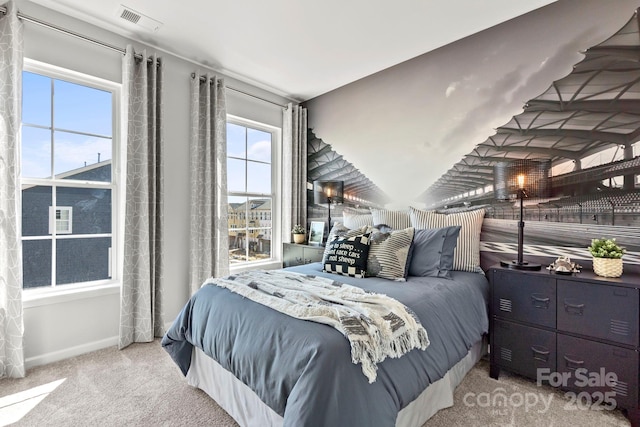 bedroom with baseboards, visible vents, and light colored carpet