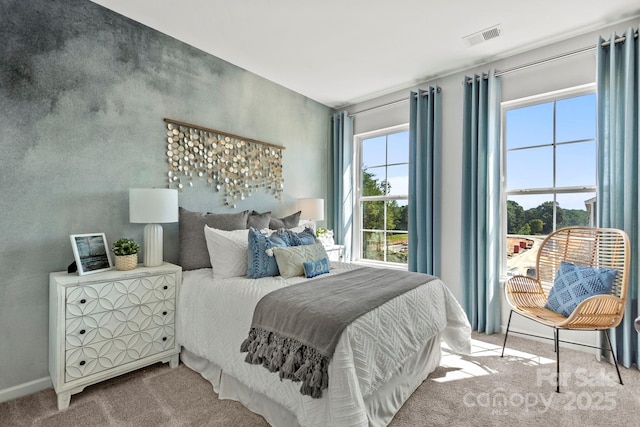 carpeted bedroom featuring visible vents