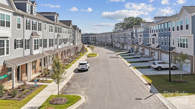 view of road featuring curbs, sidewalks, and a residential view