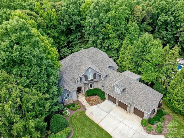 drone / aerial view featuring a wooded view