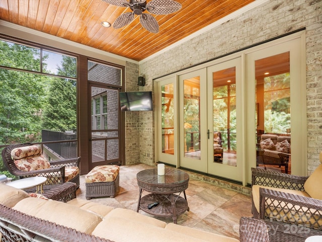 sunroom featuring wooden ceiling, a ceiling fan, and french doors