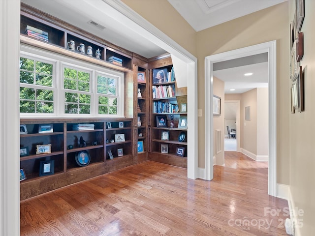 interior space featuring wood finished floors, visible vents, and baseboards