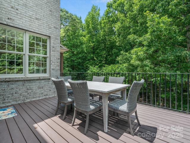 wooden terrace with outdoor dining space