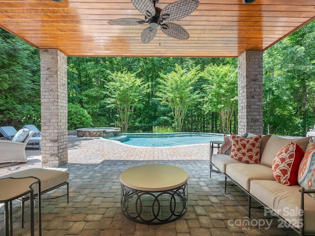 view of patio with a pool with connected hot tub, outdoor lounge area, and a ceiling fan