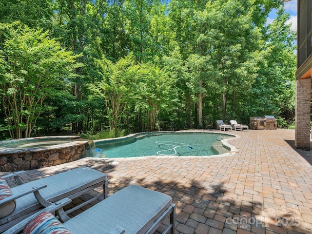 view of pool with a pool with connected hot tub and a patio