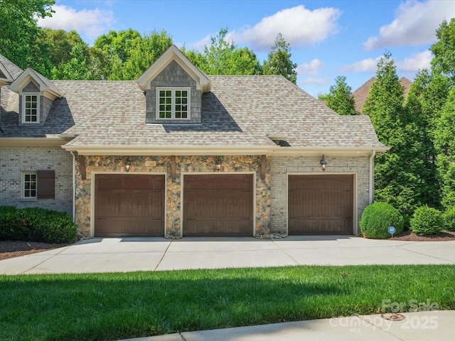 view of front of home featuring a garage, driveway, and roof with shingles