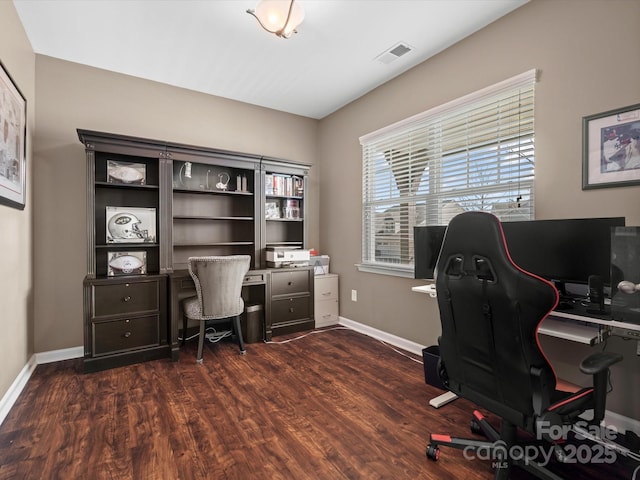 office space featuring dark wood-type flooring, visible vents, and baseboards