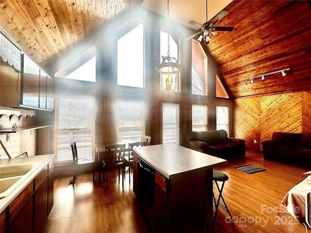 kitchen featuring dishwashing machine, wooden ceiling, dark wood-style floors, and open floor plan