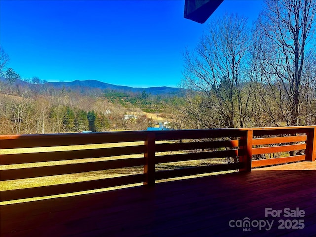 exterior space with a wooded view and a mountain view