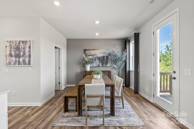 dining room with light wood-style floors, baseboards, and recessed lighting