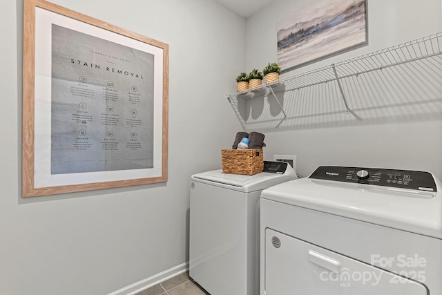 washroom featuring laundry area, independent washer and dryer, baseboards, and light tile patterned floors
