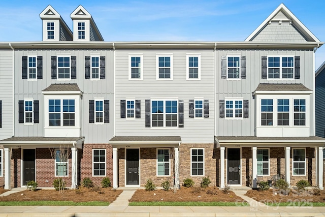 multi unit property featuring board and batten siding and brick siding