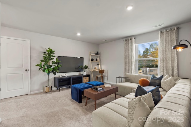 living area with baseboards, recessed lighting, visible vents, and light colored carpet