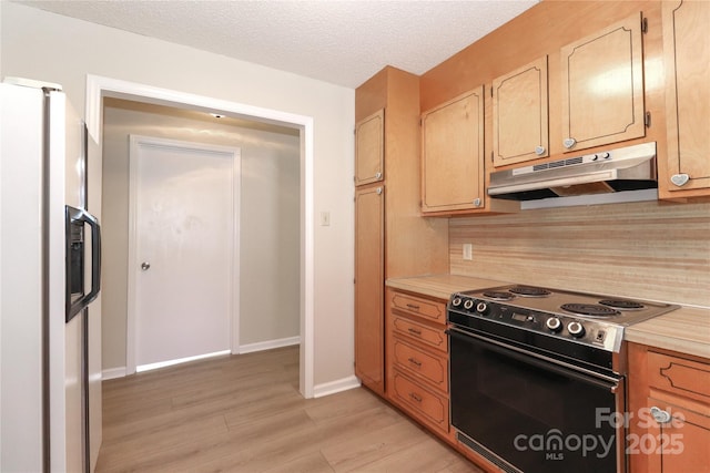 kitchen with light countertops, range with electric cooktop, white fridge with ice dispenser, and under cabinet range hood