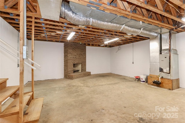 unfinished basement featuring a brick fireplace