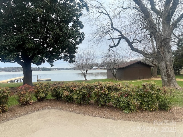 surrounding community featuring an outbuilding and a water view