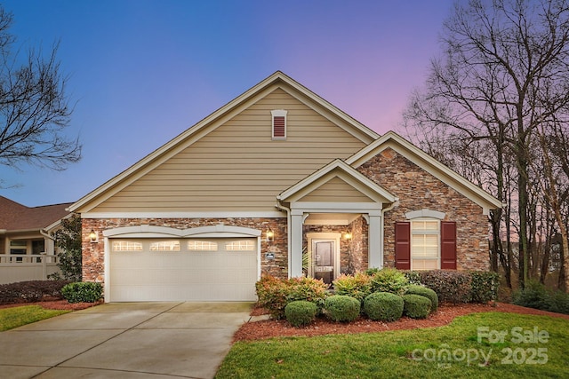 view of front of house with stone siding, concrete driveway, and an attached garage