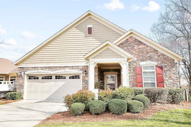 view of front of property with stone siding, concrete driveway, and a garage