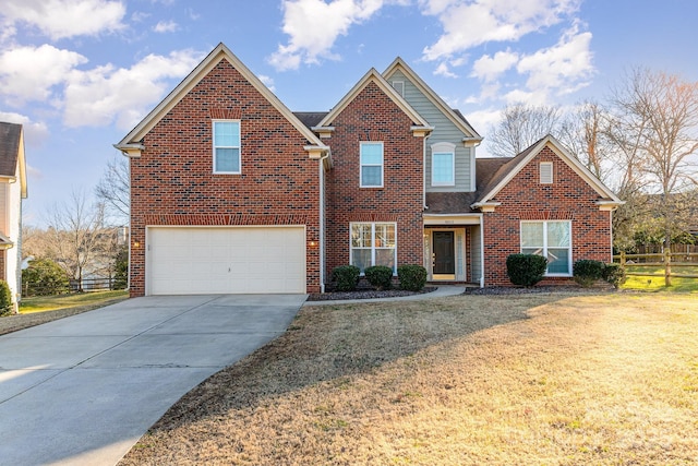 traditional-style house featuring an attached garage, brick siding, fence, concrete driveway, and a front yard