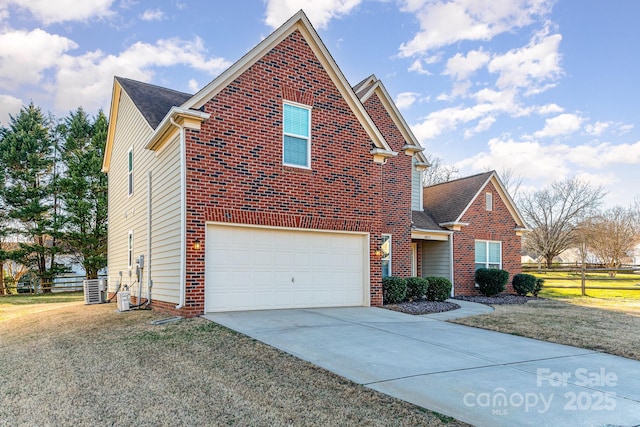 traditional-style home featuring concrete driveway, brick siding, and fence