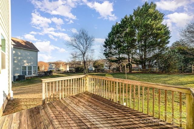 wooden terrace featuring cooling unit, a lawn, and a residential view