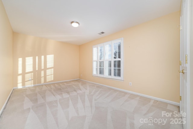 empty room with light carpet and baseboards