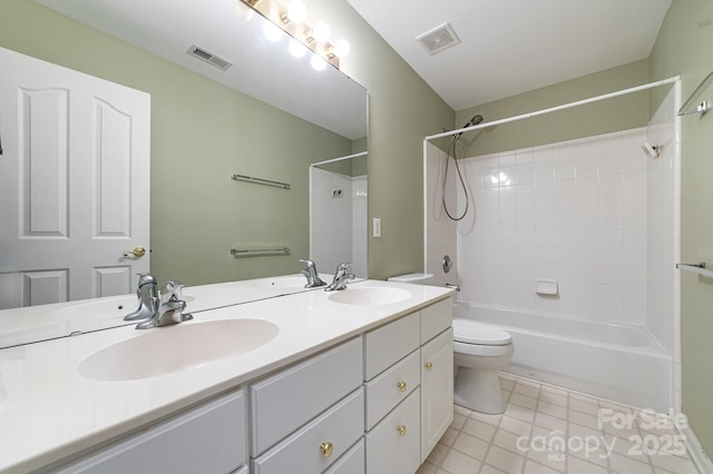 bathroom with toilet, a sink, and visible vents