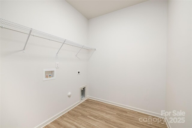 laundry room featuring hookup for a washing machine, hookup for an electric dryer, light wood-type flooring, laundry area, and baseboards