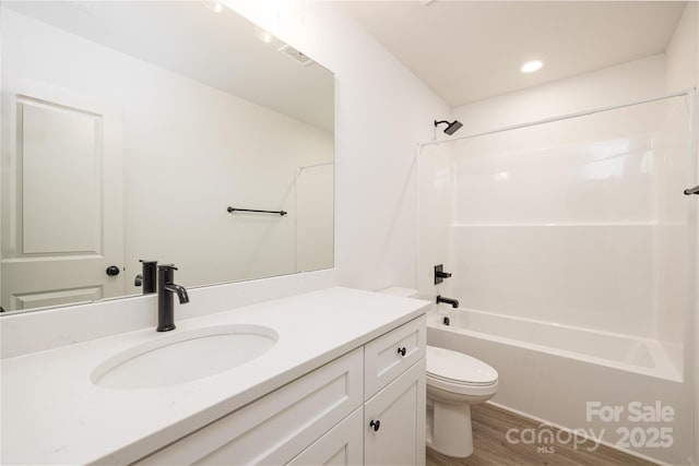 full bathroom with bathtub / shower combination, visible vents, toilet, vanity, and wood finished floors