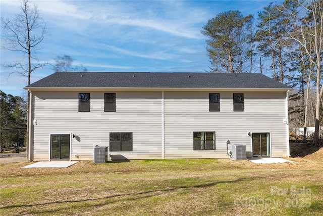 rear view of property with cooling unit, a yard, and a patio