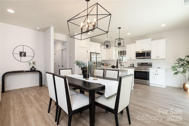 dining space featuring light wood-style floors, visible vents, baseboards, and recessed lighting