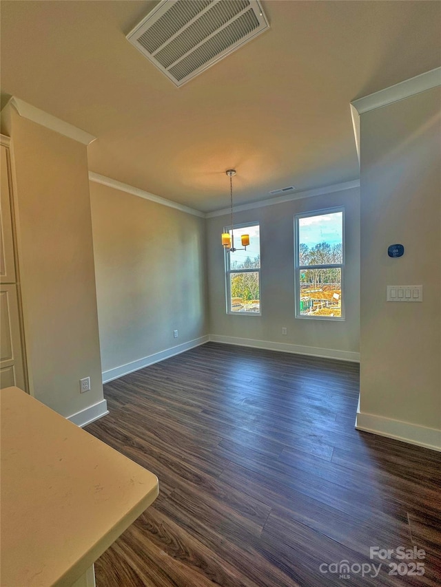 unfurnished dining area featuring ornamental molding, dark wood finished floors, visible vents, and baseboards