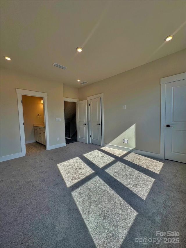 spare room featuring baseboards, carpet floors, visible vents, and recessed lighting