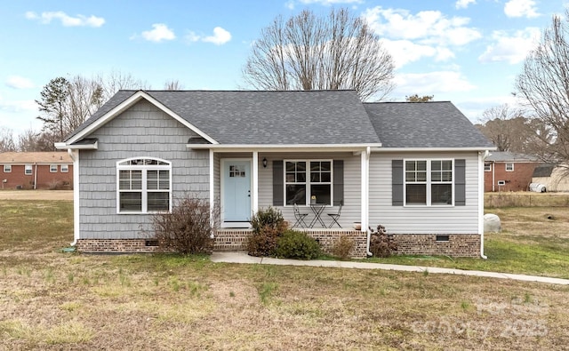 view of front facade with crawl space, a shingled roof, a porch, and a front lawn