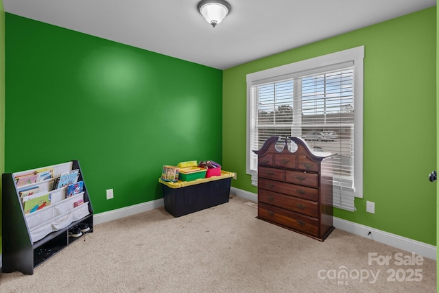 playroom with carpet floors and baseboards