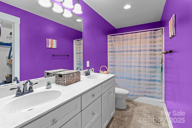 full bathroom featuring toilet, double vanity, shower / bath combo, and a sink