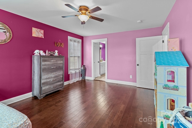 bedroom with baseboards, dark wood finished floors, a ceiling fan, and ensuite bathroom